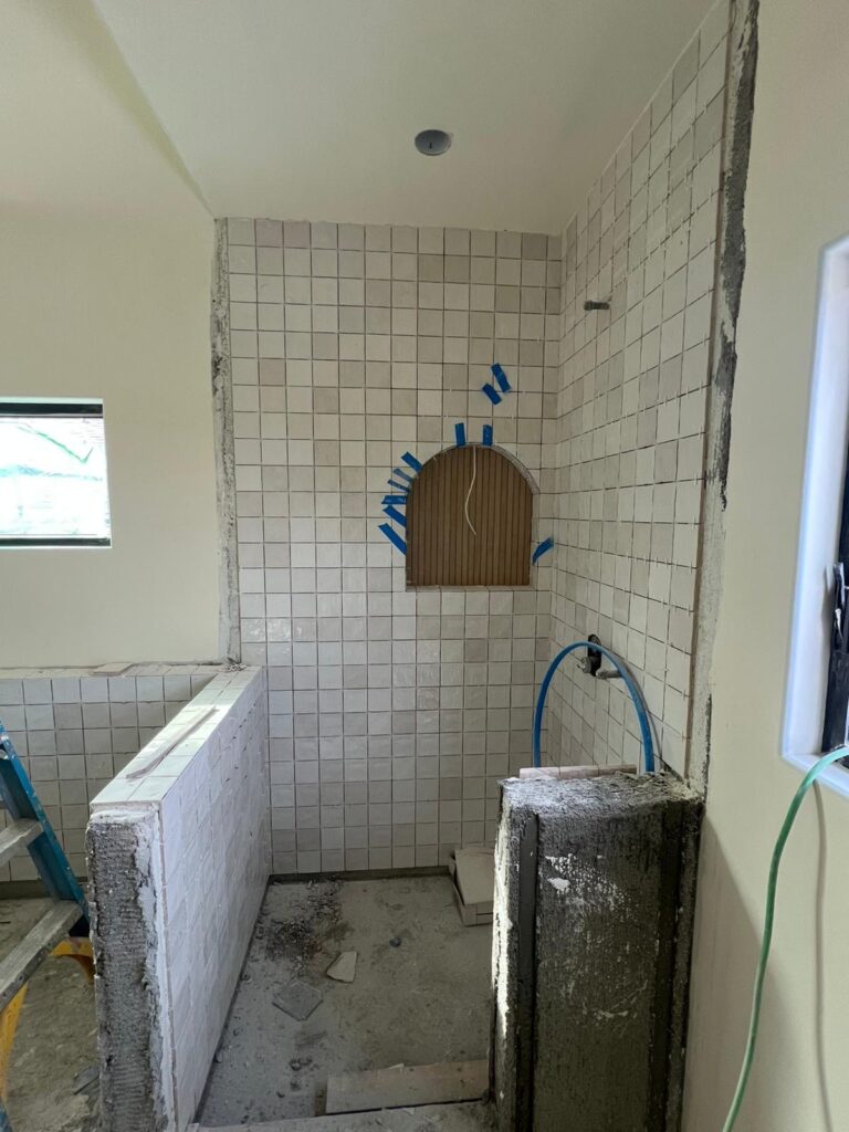 Custom bathroom renovation with tile and vanity by Greenwood Contractors